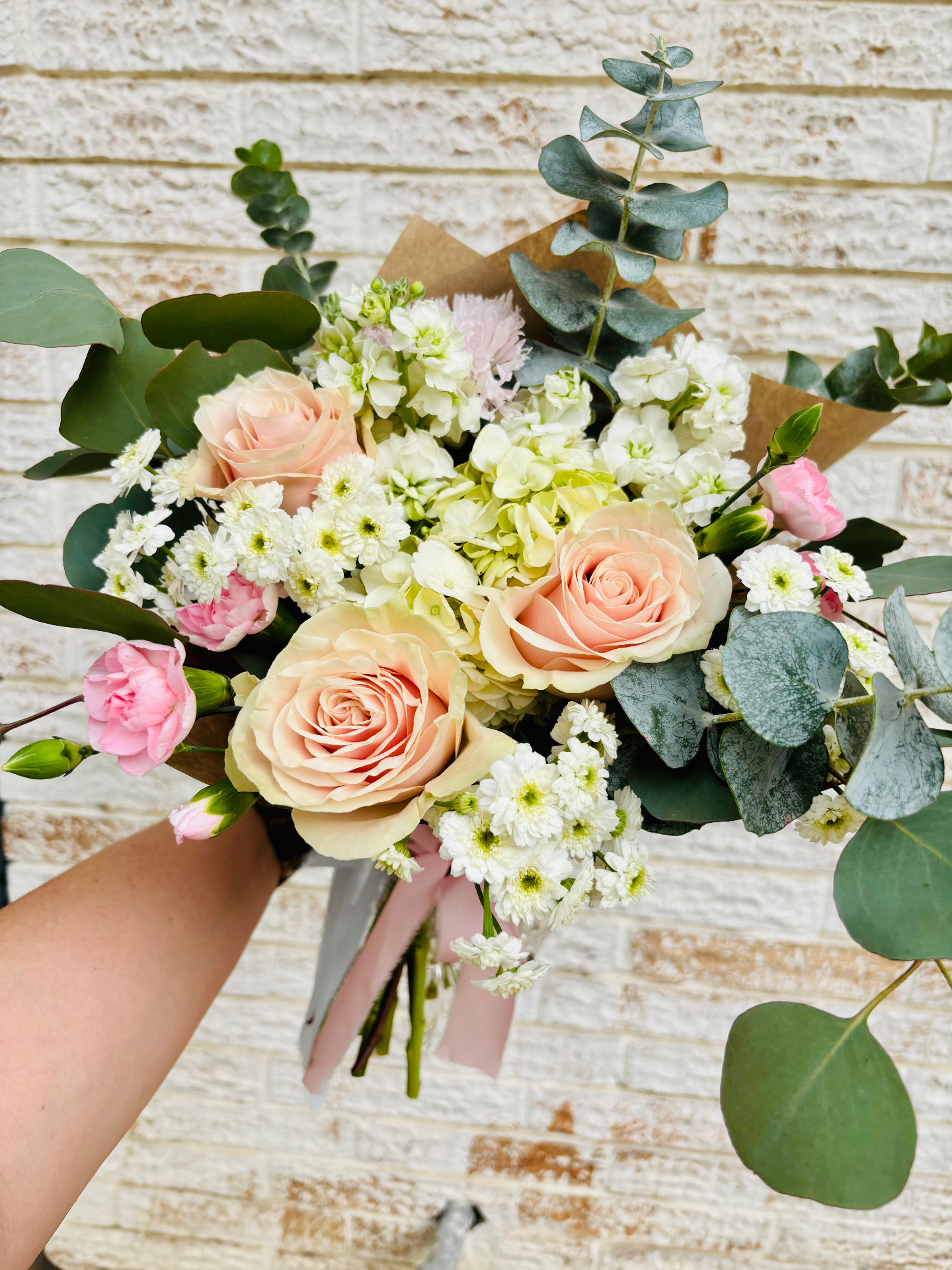 Peach rose bouquet with eucalyptus and pink accents