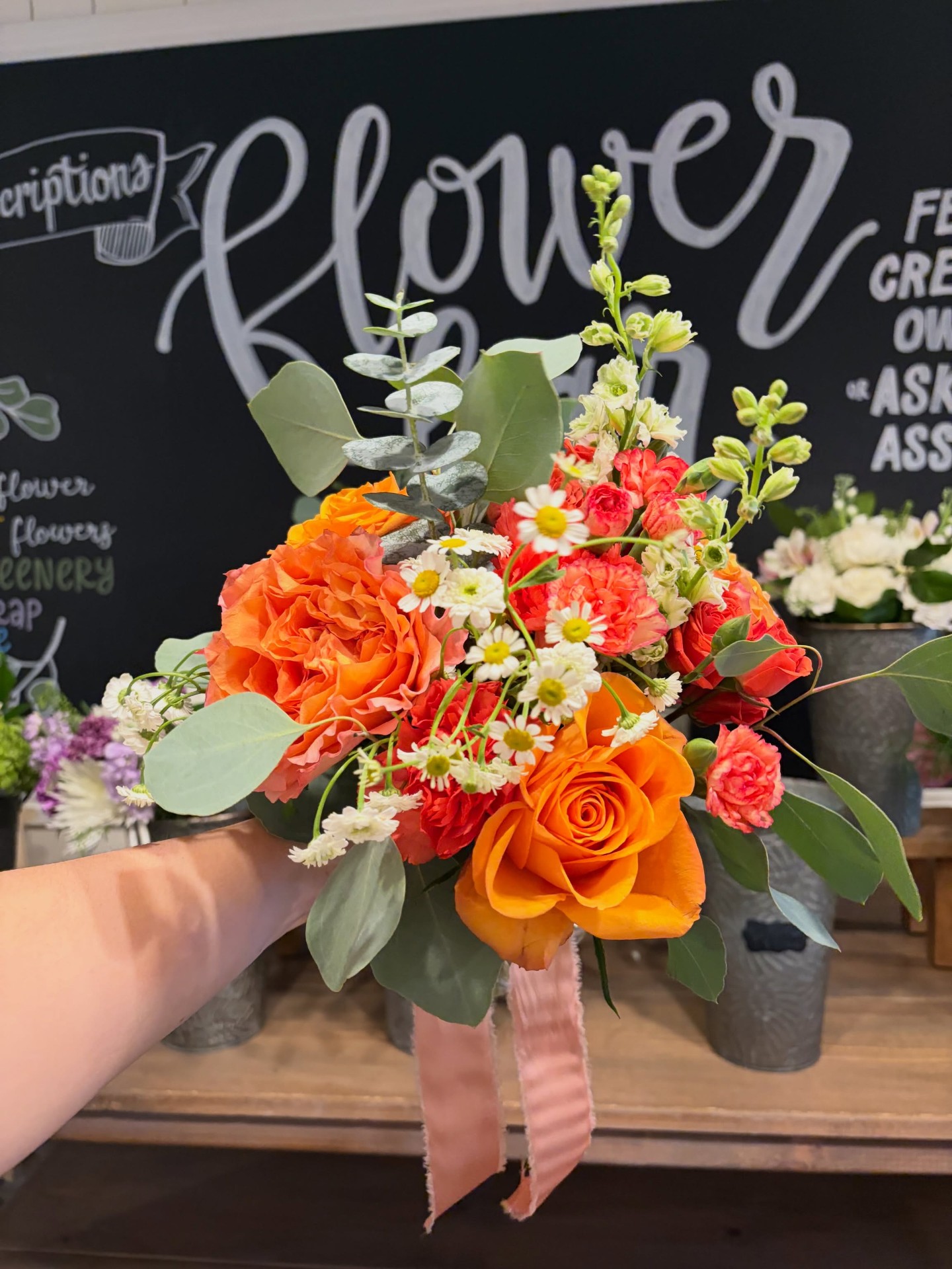 Orange and coral bouquet at the flower bar