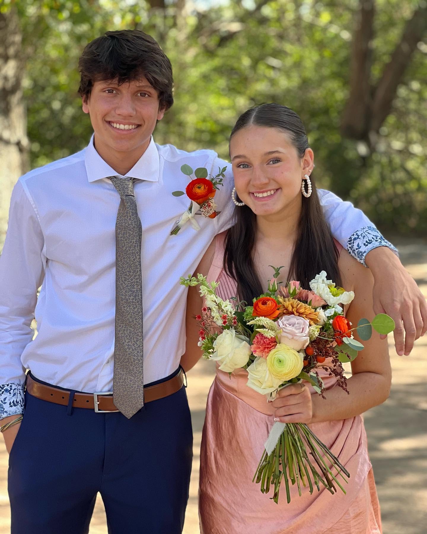 Couple with boutonniere and bouquet outdoors